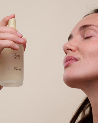 Woman misting her face with Rose + Lavender Reviving Mist