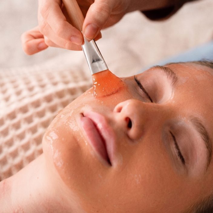 Applying the treatment with a brush to clean, dry skin