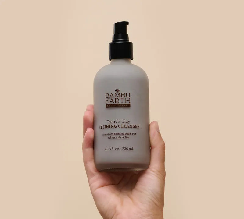 Hand holding the 8 fl oz professional French Clay Refining Cleanser