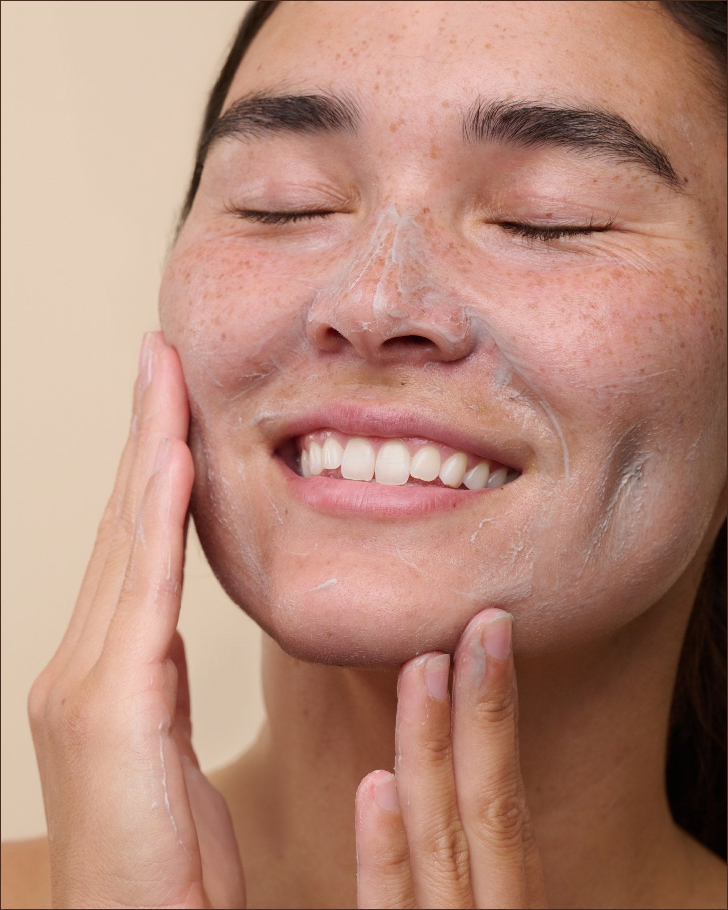 Client with the French Clay Refining Cleanser massaged into the skin