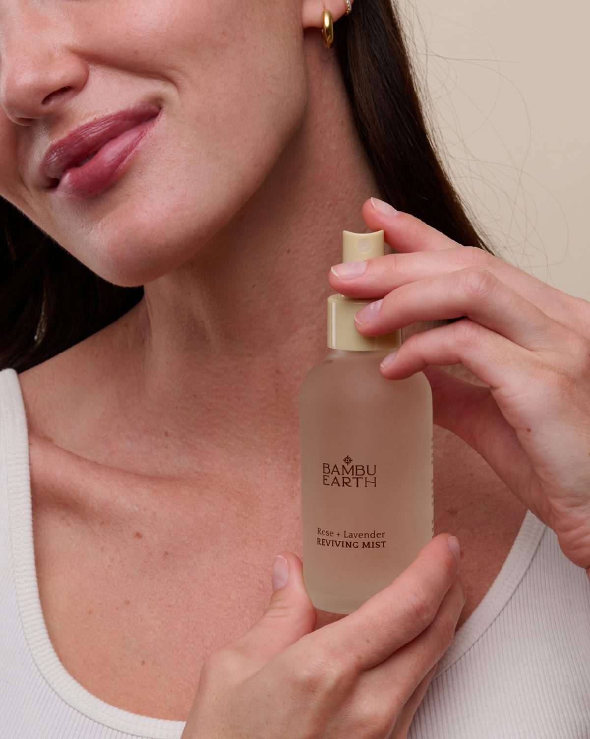 Client holding the Rose + Lavender Reviving Mist